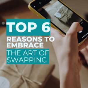 This is a photo of a poster with the text 'TOP 6 REASONS TO EMBRACE THE ART OF SWAPPING' and a person holding a phone taking a picture of a parcel swap.