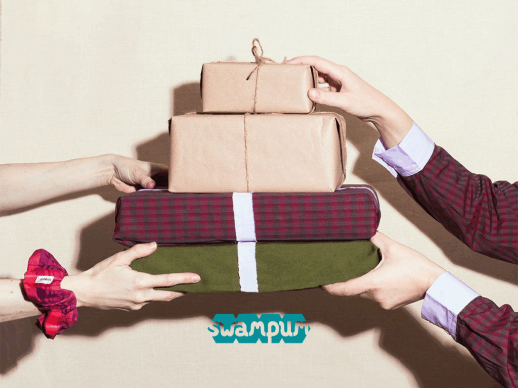 Stack of wrapped Christmas presents being exchanged, representing meaningful secondhand gift ideas and thoughtful suggestions from our holiday gifting guide by Swampum.